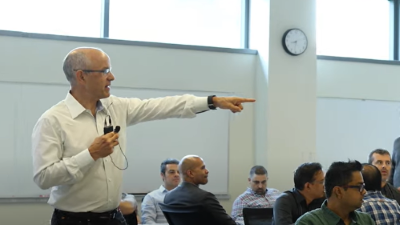 photo in a classroom with professor pointing to something