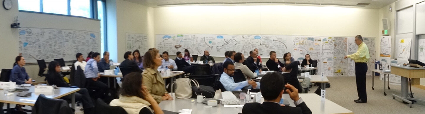 image of MIT faculty Roberto Fernandez teaching in classroom surrounded by scribing