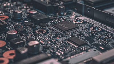 Close-up of a computer motherboard showing integrated circuits, capacitors, and electronic components.