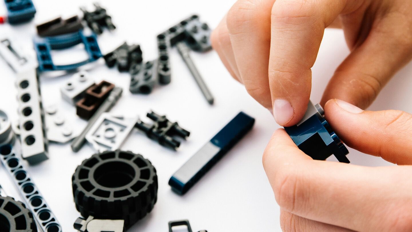hand playing with lego pieces