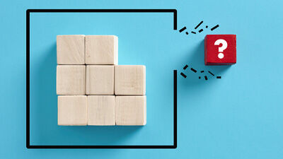 a red block with a question mark on it breaking free from other blocks