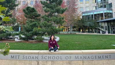 Carla Silvado on the lawn in front of MIT Sloan Building e62