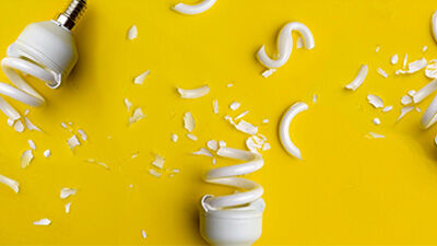 broken lightbulbs against yellow background