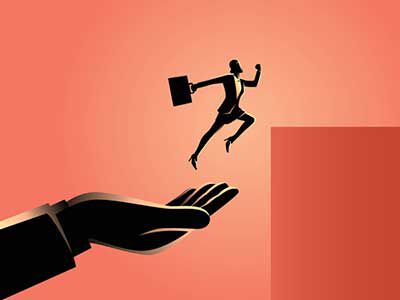 person leaping off large hand