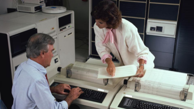 man and woman talking in an office in the 1990s