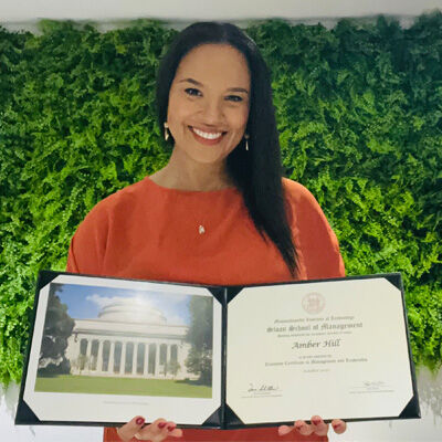 image of Dr. Amber Hill standing in front of greenery holding open her Executive Certificate in Management and Leadership image of Dr. Amber Hill standing in front of greenery holding open her Executive Certificate in Management and Leadership