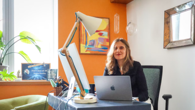 Regina Barzilay at her desk behind her laptop