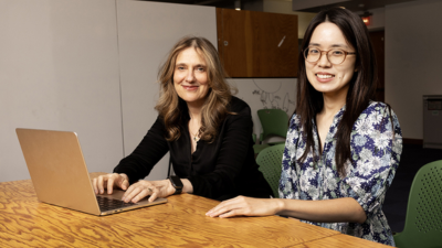 Regina Barzilay sitting with a researcher