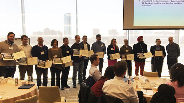 Group of executive education participants holding certificates during a graduation or course completion ceremony
