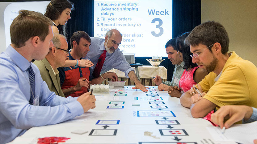 Participants engaged in a hands-on simulation exercise called the beer game during a course.