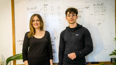 photo of a man and woman in front of a white board
