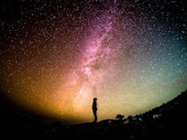 person in front of stars in sky