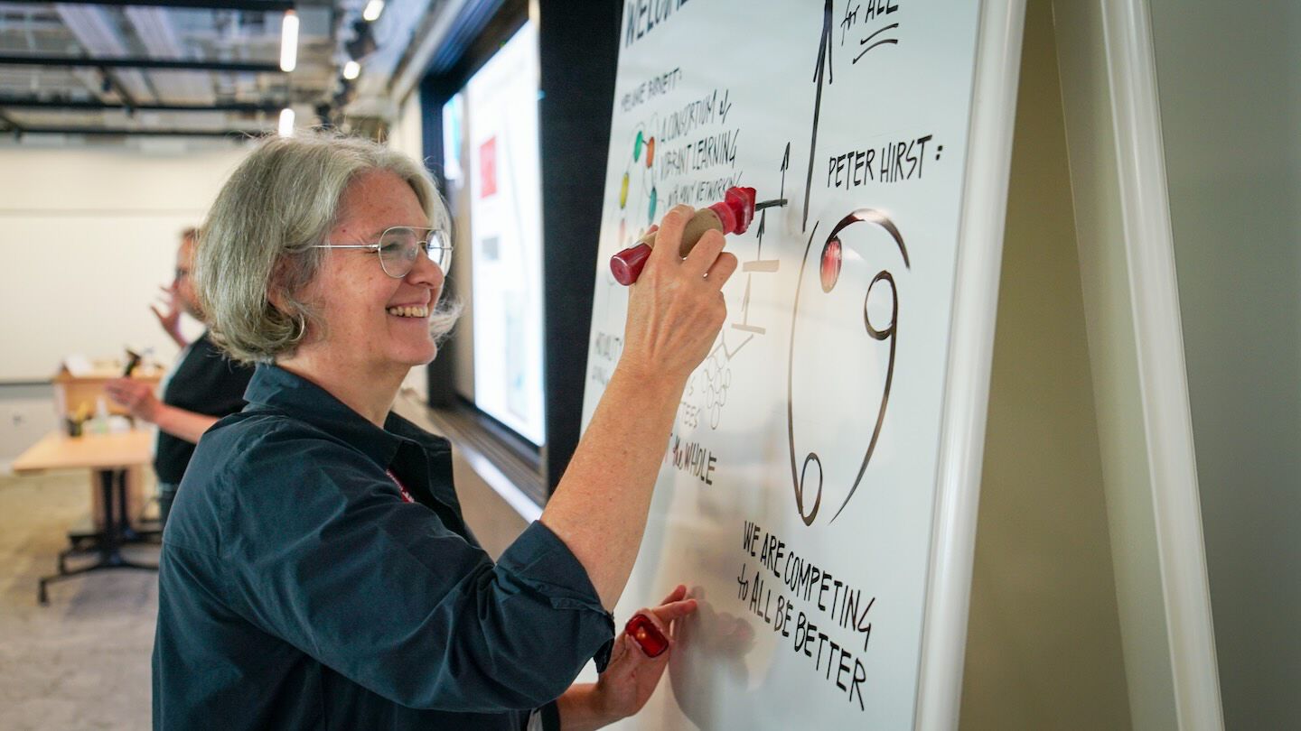 photo of faculty member drawing on a white board