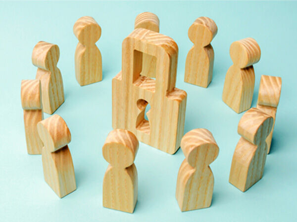 blocks shaped like people around padlock