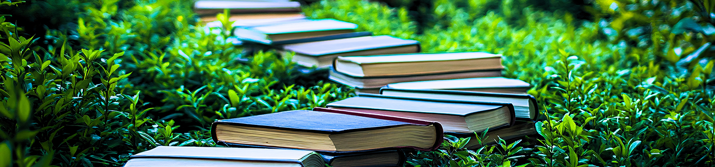 books laying in a jungle creating a path