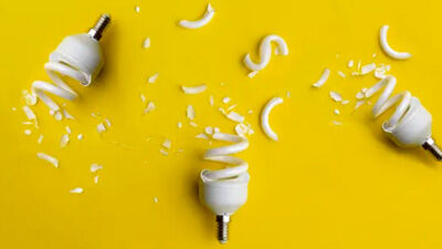 broken lightbulbs against yellow background