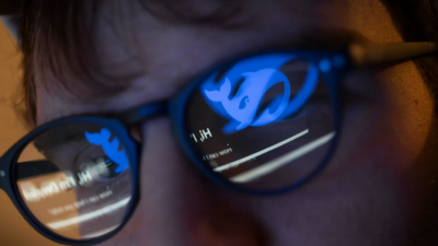 man staring at blue whale reflection in eyeglasses