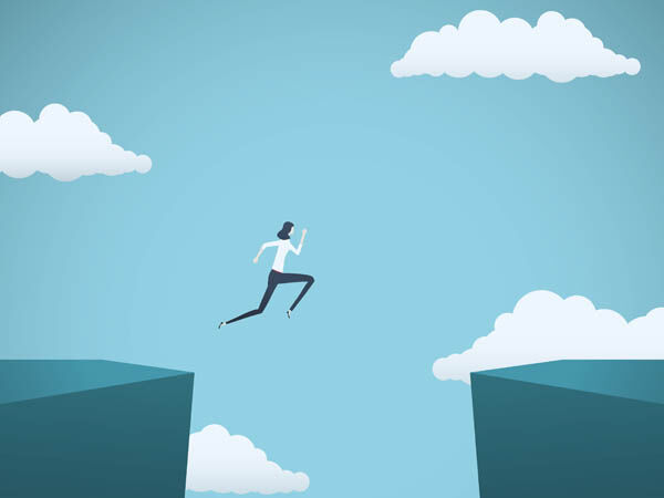 woman leaping across a ravine