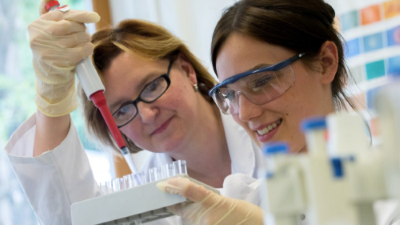 photo of two women working in a lab with scientific equipment