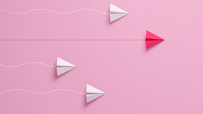 pink background with pink and white paper planes racing