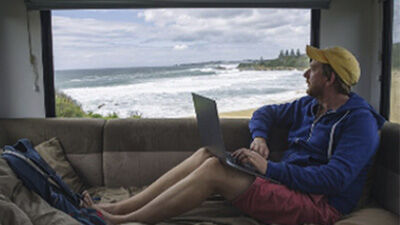 person in a camper looking a the ocean