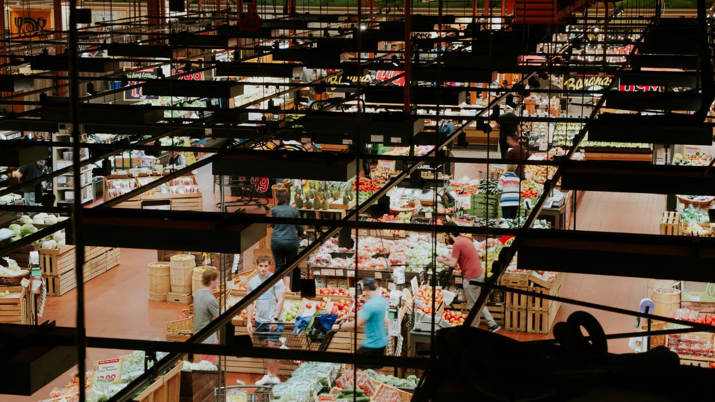 birds eye view of a grocery store people walking and shopping