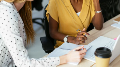 photo of two women working at a desk together