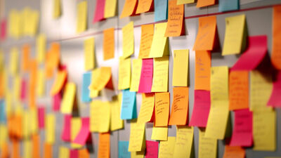 an assortment of post-it notes on a board