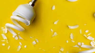 photo of broken lightbulbs on a yellow background