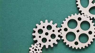 wood cogs against a green background