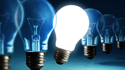 line of dim lightbulbs with one lit bulb peeking out