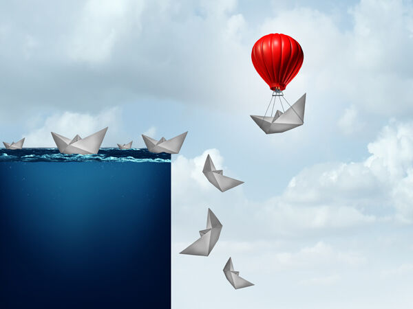 paper boats going off cliff while one flies