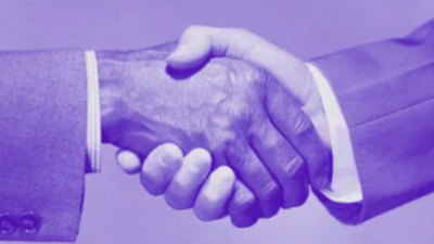 two men in suits shaking hands with a purple overlay