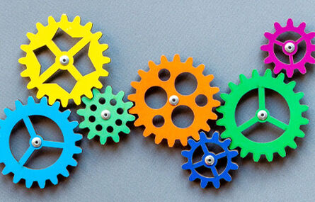 multicolored cogs linked together