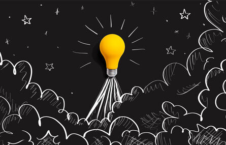 lightbulb depicted as a rocket against a black background