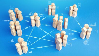 small groups of wooden people connected by lines image number null
