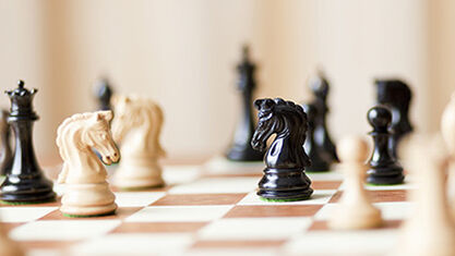 Photograph of chess pieces on a chess board. image number null