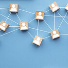Wooden blocks with images of people, connected by a web.