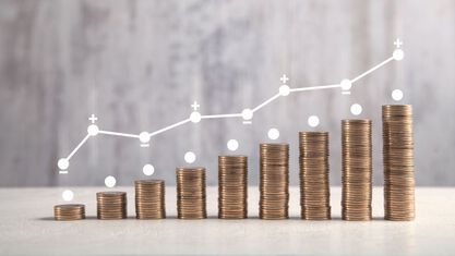nine stacks of coins getting progressively taller with a line graph above  image number null