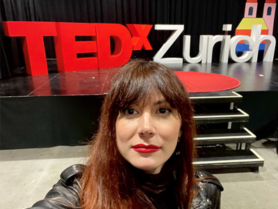 Georgia Tagara taking a selfie in front of TEDX Zurich stage