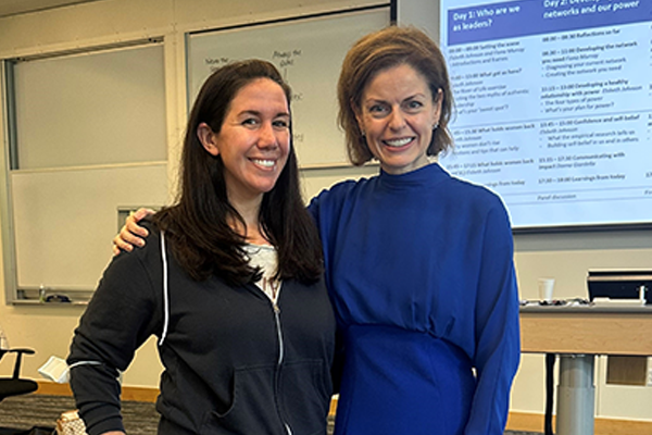 Jillian Kaplan (L) standing with MIT Sloan faculty Elsbeth Johnson (R) in the classroom of the Women's Leadership Program