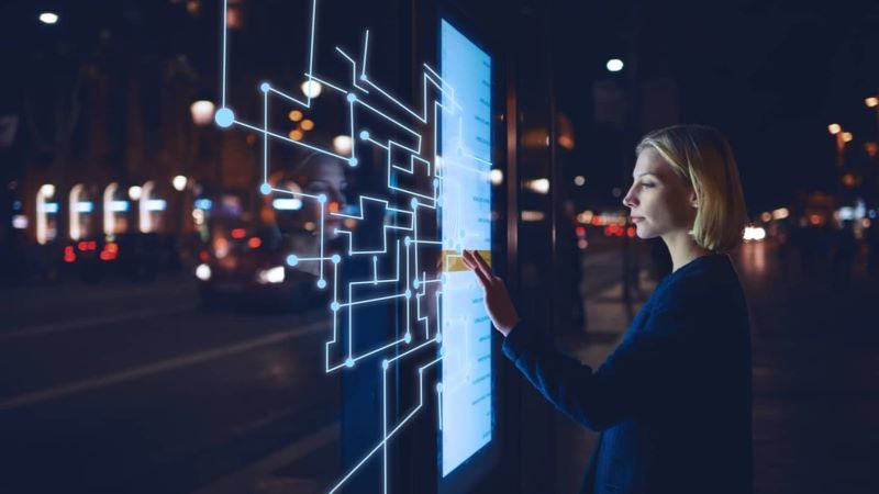 image of a woman touching a virtual board