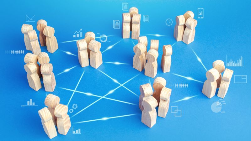 small groups of wooden people connected by lines
